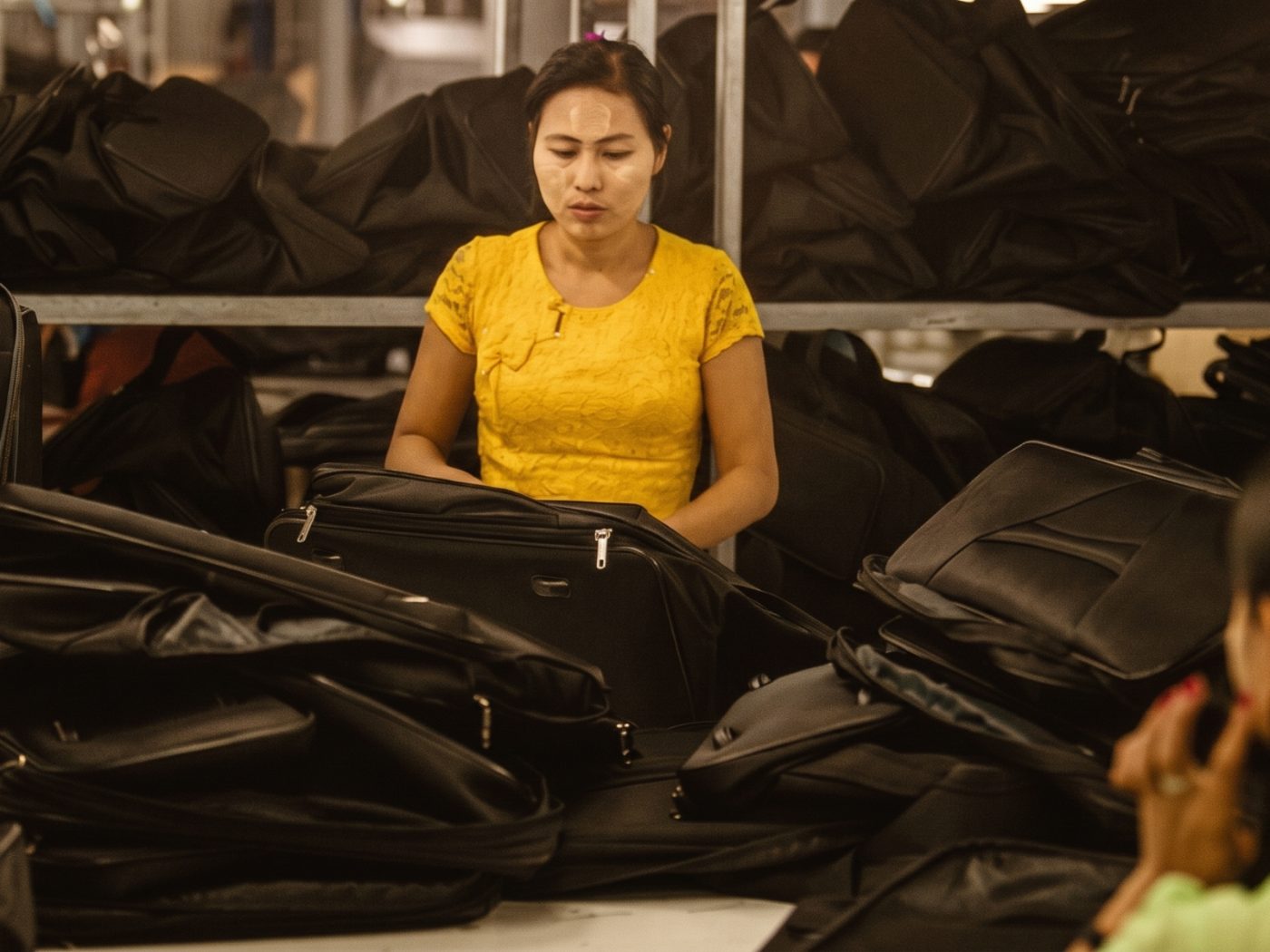 Operator performing inline quality control on finished bags